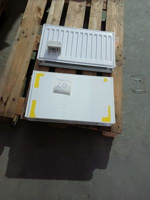 a white refrigerator sitting on a pallet in a warehouse