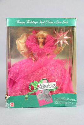 doll in a pink dress in a box with a star on top