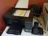 a printer and a cell phone sitting on a desk