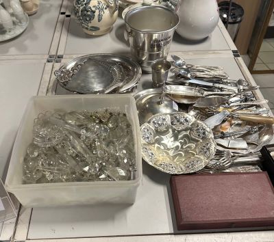 a table with a lot of silverware and silverware on it