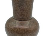 a brown vase that is sitting on a white surface