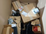 a cardboard box filled with electronic equipment and other items