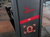 a black and red machine in a gym room
