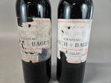 two bottles of wine sitting next to each other on a table