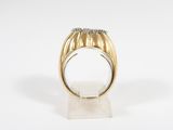 a close up of a gold ring with diamonds on a white surface