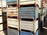 many crates stacked on top of each other in the dirt