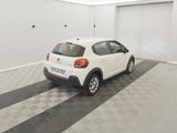 the small white car is parked in the garage of the building