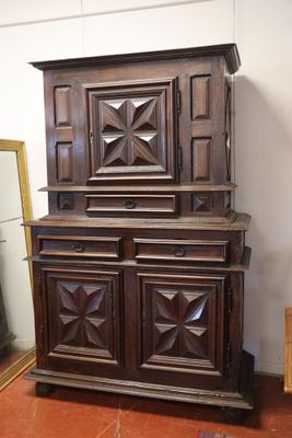a wooden cabinet with a mirror on top of it
