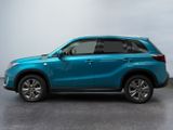 the blue suv is parked in a room with a white wall