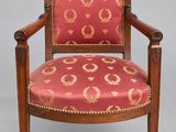a wooden chair with red and gold upholstered upholstered seat