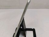 a close up of a cell phone on a stand on a table