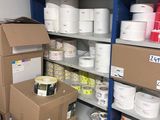 many boxes of paint on the shelves in the room