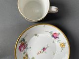 two cups and a saucer are sitting on a table