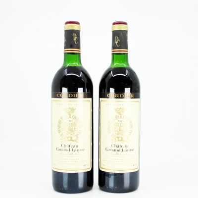 two bottles of wine sitting next to each other on a table