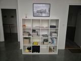 a picture of a book shelf in the corner of a room