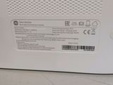 the back of a white microwave oven sitting on top of a counter