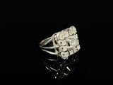 a close up of a diamond ring on a black surface