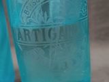 two blue glass bottles sitting next to each other on a table