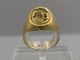 an image of a gold ring with a monogram on it