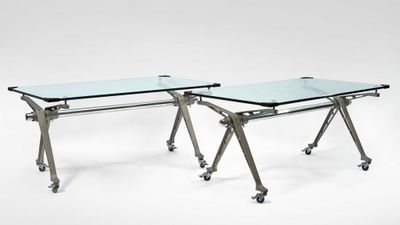 pair of chrome and glass desks on casteors with wheels