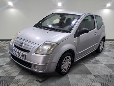 a picture of a small silver car parked in a garage