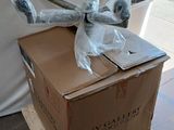 a cardboard box with a stuffed animal on top of it