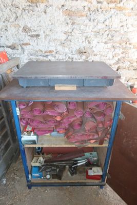 a metal shelf with a bunch of pink shoes on it