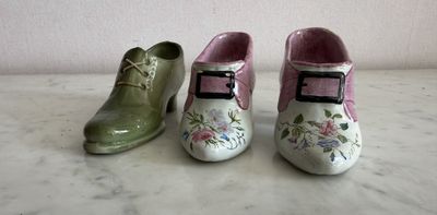 three pairs of shoes that are sitting on a table