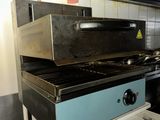 a stove that is sitting in a kitchen next to a stove top