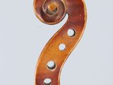 a close up of a violin neck with a fiddle in the background