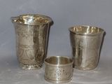 three silver cups sitting next to each other on a table