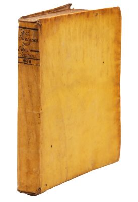 an old book sitting on top of a white surface