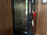 a dry age refrigerator in the corner of a room