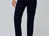 the woman is wearing a white t - shirt and blue jeans