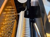 a clock on the side of a piano in a room
