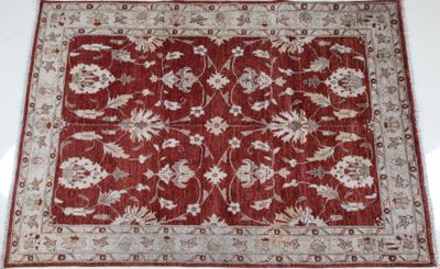 a close up of a red rug on a white floor