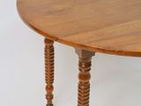 a wooden table with two legs and a round top