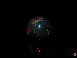 an oplite sphere with a black background in the dark