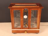 a small wooden case with a clock inside of it