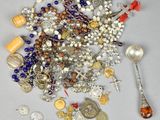 a pile of beads and a spoon on a table