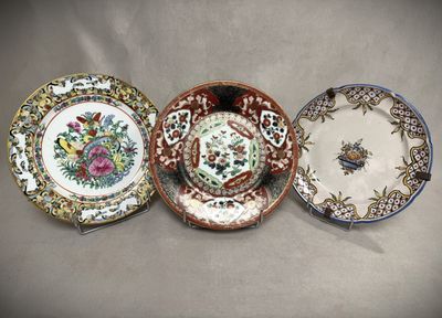 three plates with different designs on them sitting on a table
