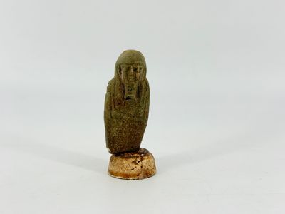an image of a statue of an owl sitting on top of a wooden base