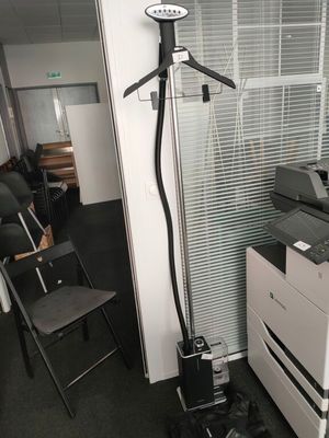 a photo of a room with a printer and a chair