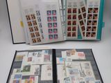 an open book with stamps on it sitting on top of a table