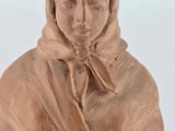 statue of a woman with a hood on her head and a scarf around her neck