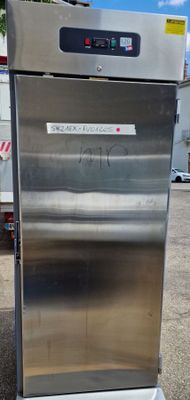 a stainless steel machine that is sitting in a parking lot