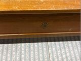 a wooden table with a drawer on top of it