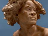 a statue of a woman that is sitting on a table