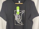 black t - shirt with a butterfly design on the front and a green tag on the back