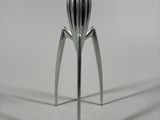 a metal object that looks like a fruit squeezer
